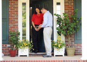 Woman speaking with a pest control technician at her home